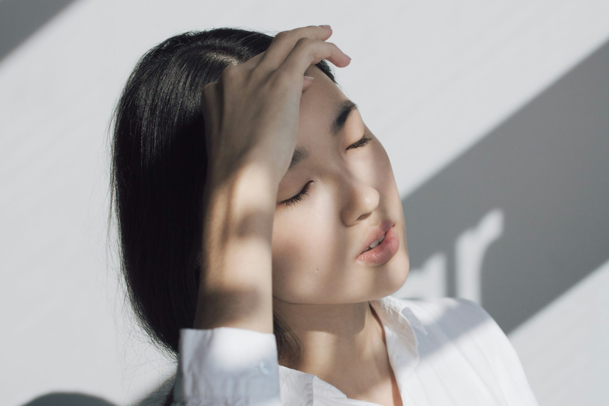 woman covering her face from the light