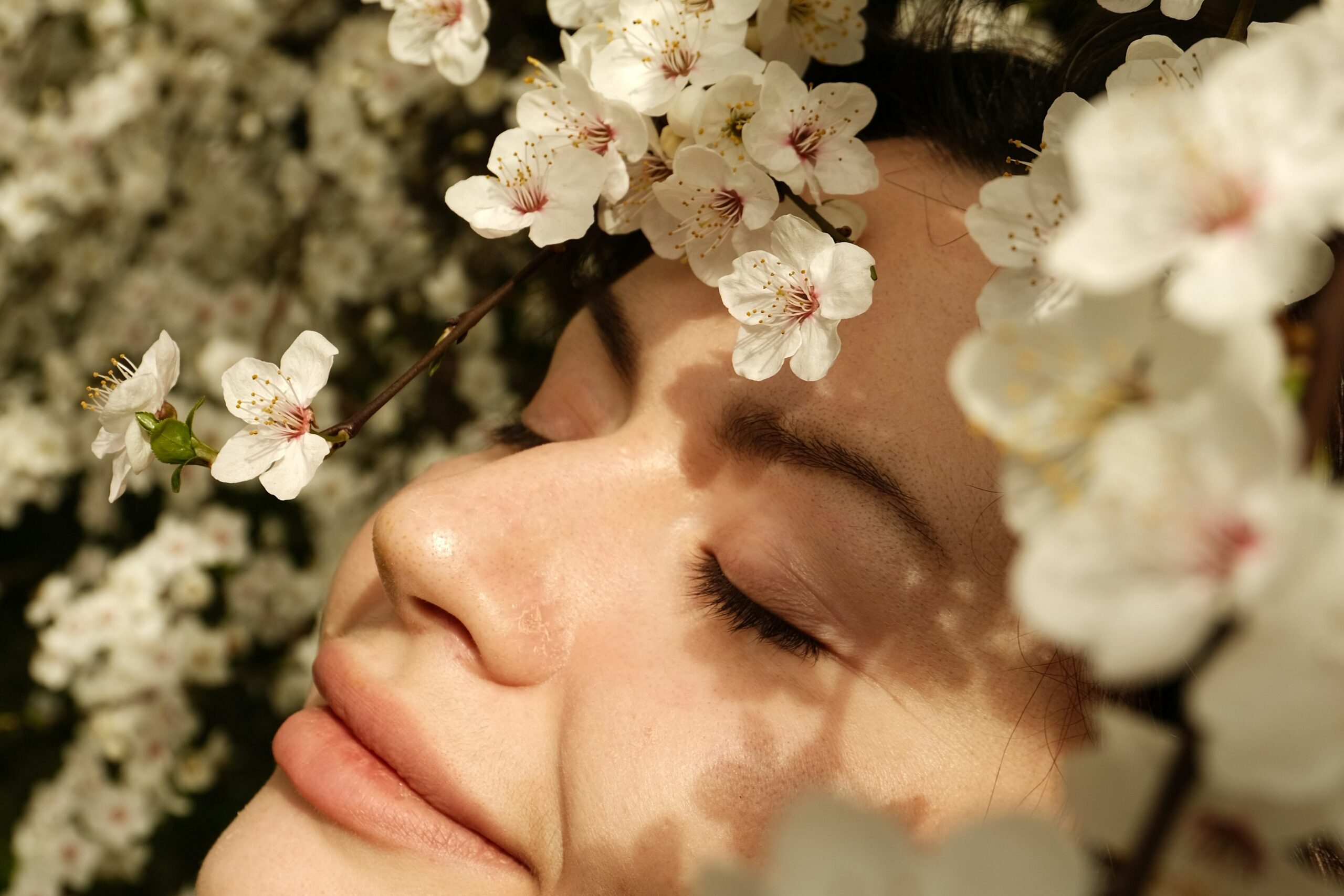 woman basking in the sun surrounded by flowers